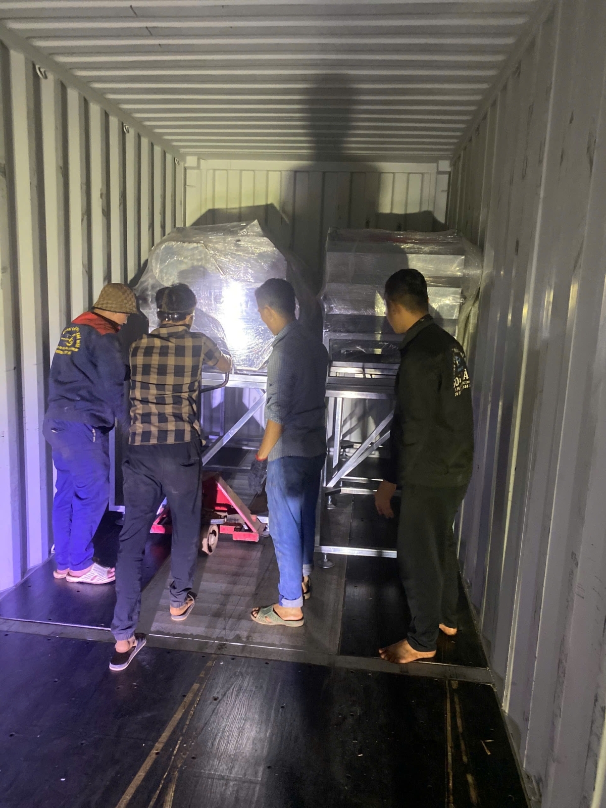 Packing a container of processing machinery for shipment to Tanzania.