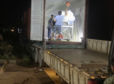 Packing a container of processing machinery for shipment to Tanzania.