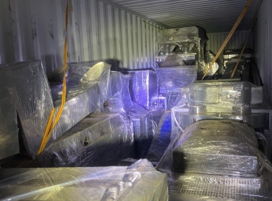 Packing a container of processing machinery for shipment to Tanzania.