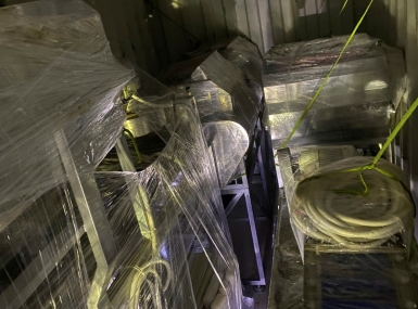 Packing a container of processing machinery for shipment to Tanzania.