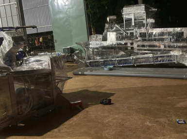 Packing a container of processing machinery for shipment to Tanzania.