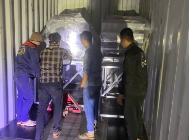 Packing a container of processing machinery for shipment to Tanzania.